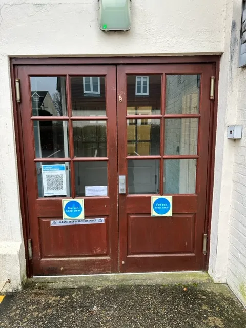 a red door with two signs on it
