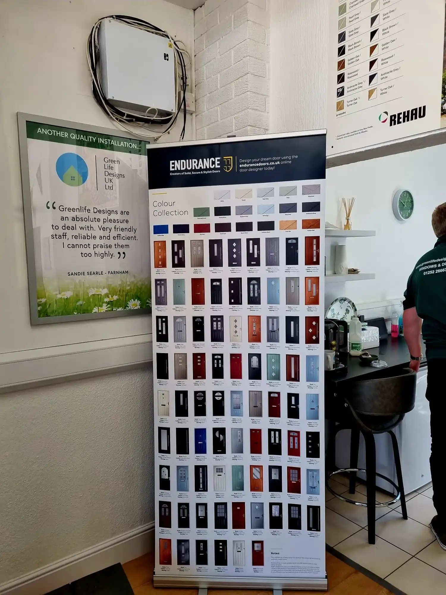 there is a man standing next to a display of cell phones